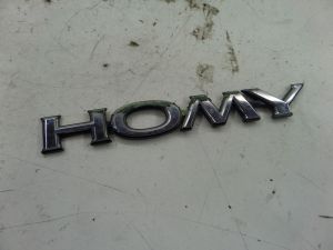 Nissan Elgrand JDM RHD Homy Emblem E50 VE000 97-02 OEM